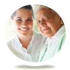 caregiver and old woman smiling in front of the camera