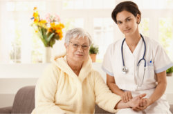 personal nurse and old woman looking at the camera
