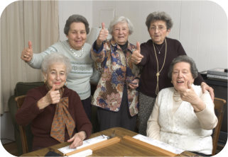 group of elderly people with thumbs-up pose while smiling